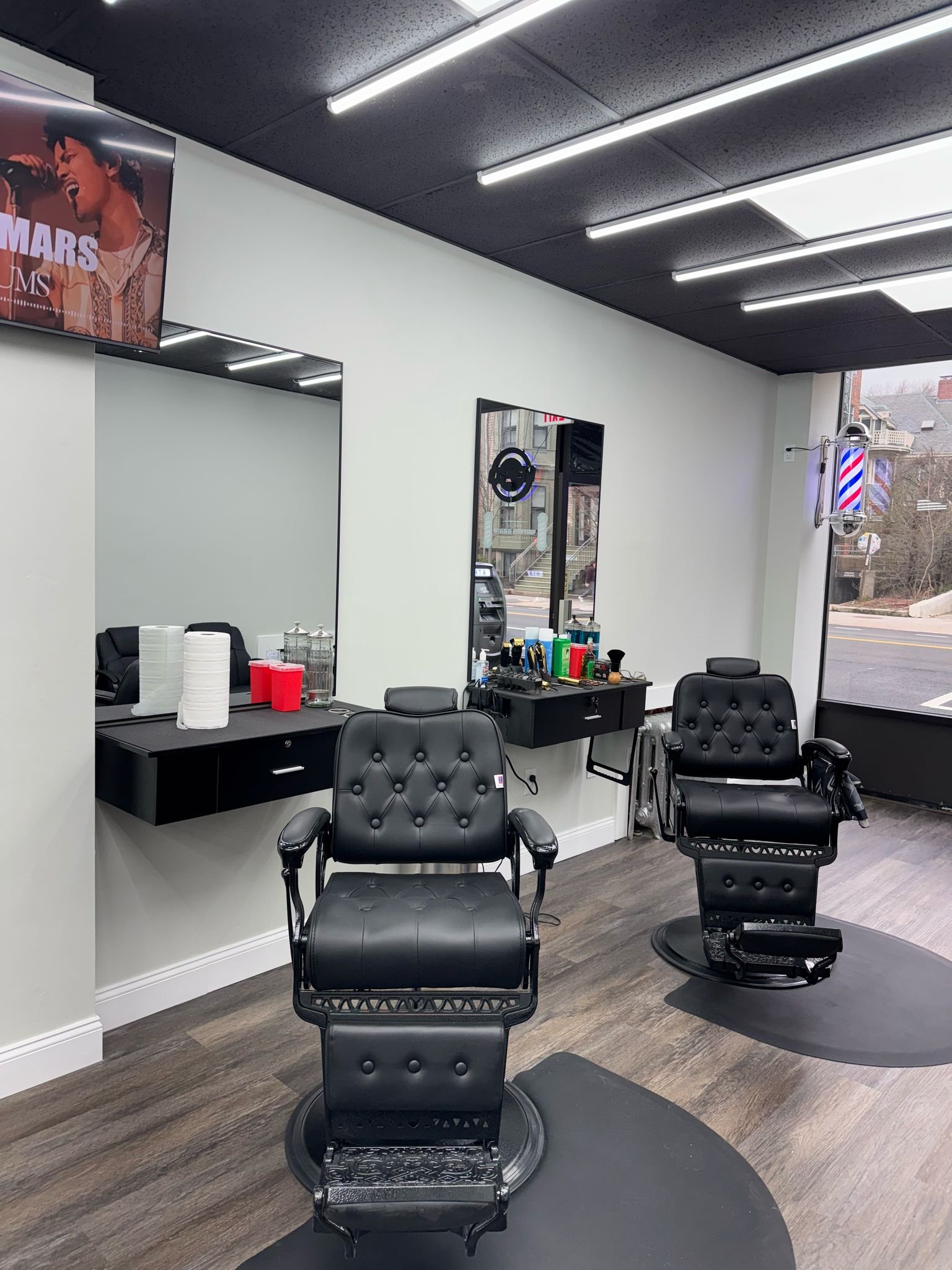 Belvedere Barbershop interior — premium black tufted chairs, clean modern space
